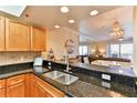 Kitchen with granite countertop bar open to the dining and living rooms at 5300 S Atlantic Ave # 12-403, New Smyrna Beach, FL 32169