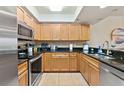 Well-equipped kitchen with granite countertops, stainless steel appliances, and ample cabinet space at 5300 S Atlantic Ave # 12-403, New Smyrna Beach, FL 32169