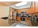 Well-lit kitchen featuring granite countertops and modern stainless-steel appliances at 5300 S Atlantic Ave # 12-403, New Smyrna Beach, FL 32169