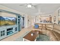 Inviting living room featuring a comfortable leather sofa, stylish furniture, and a seamless flow into the kitchen area at 5300 S Atlantic Ave # 12-403, New Smyrna Beach, FL 32169