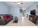 Comfortable living room with tile flooring, ceiling fan, and plenty of natural light at 5513 Estero Loop, Port Orange, FL 32128