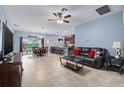 Open-concept living space with tile flooring, leading to the dining area and kitchen at 5513 Estero Loop, Port Orange, FL 32128