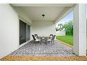 Cozy covered patio with brick flooring, ideal for outdoor dining and relaxation at 5513 Estero Loop, Port Orange, FL 32128
