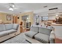 Bright and airy living room with a view into kitchen, creating a cohesive living space at 5967 Plantera Ct, Port Orange, FL 32127