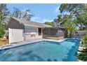 Backyard pool with screened lanai, perfect for outdoor relaxation and entertaining at 5967 Plantera Ct, Port Orange, FL 32127