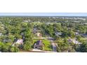 Aerial view of home in neighborhood with surrounding trees and landscaping at 701 N Tuxedo Ave, Deland, FL 32724