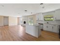 Bright kitchen features white cabinets, subway tile backsplash, and center island at 825 Wells Dr, South Daytona, FL 32119