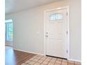 Inviting entryway featuring a decorative glass front door, tile flooring, and neutral paint at 832 Wildwood Cir, Port Orange, FL 32127