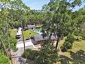 Beautiful aerial shot of a home with a pool, RV parking, and a peaceful, wooded setting at 851 W Wisconsin Ave, Orange City, FL 32763