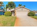 Inviting home exterior with a well-maintained lawn and a spacious two-car garage at 929 N Lakewood Ter, Port Orange, FL 32127