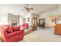 Bright living room with a brick fireplace, a ceiling fan, and comfortable seating at 929 N Lakewood Ter, Port Orange, FL 32127