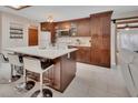 Modern kitchen boasting dark wood cabinetry, white countertops, a spacious island, and stainless steel appliances at 953 Tulip St, Deltona, FL 32725