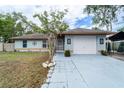 Charming single-story home with a two-car garage, well-maintained landscaping, and inviting curb appeal at 1113 Fort Smith Blvd, Deltona, FL 32725