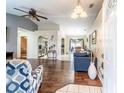 Spacious living room showcasing hardwood flooring and an open floor plan connecting to the kitchen and dining area at 1113 Fort Smith Blvd, Deltona, FL 32725