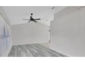 Bright living room with vaulted ceilings, ceiling fan, and modern gray wood flooring at 1141 Glendale Ave, Deltona, FL 32725