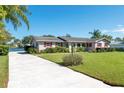 Well-maintained single-story house with a long driveway and view of the water at 1155 E Fowler Dr, Deltona, FL 32725