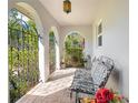 Inviting front porch area with brick floor, iron gates, and a bench for relaxing at 1155 E Fowler Dr, Deltona, FL 32725