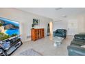 Cozy living room with tile floors, comfortable seating, and a modern entertainment center at 1155 E Fowler Dr, Deltona, FL 32725