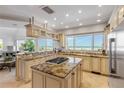 Gourmet kitchen with granite countertops, center island, stainless appliances, and stunning ocean views at 1209 N Atlantic Ave, New Smyrna Beach, FL 32169
