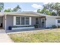 Charming single-story home with a gray exterior, decorative block accent, and covered porch at 1284 Vanderbilt Dr, Ormond Beach, FL 32174