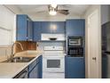Cozy kitchen with blue cabinets, ample counter space, and white appliances at 1284 Vanderbilt Dr, Ormond Beach, FL 32174