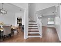Elegant dining area featuring wood floors, staircase, and view of the kitchen at 1491 Nappa Dr, Port Orange, FL 32128