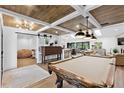Open floor plan with sliding barn door, wood ceiling, pool table, and easy access to the kitchen at 160 Point O Woods Dr, Daytona Beach, FL 32114