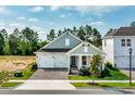 Charming single-Gathering home boasting a two-car garage, brick pathway, and a welcoming covered front porch at 16241 Honey Harvest St, Winter Garden, FL 34787