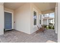 Welcoming front porch with brick flooring, comfortable seating, and a view of the friendly neighborhood at 16241 Honey Harvest St, Winter Garden, FL 34787