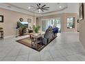 Spacious living room with tile flooring, recessed lighting, ceiling fan, and sliding glass doors to the lanai at 171 Birchmont Dr, Deland, FL 32724