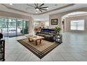 Bright living room featuring tile flooring, a large fan, recessed lighting, and sliding glass door access at 171 Birchmont Dr, Deland, FL 32724