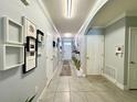 Inviting hallway features decorative art, tile flooring, arched doorway, and access to multiple rooms at 1759 Copinger Ter, Kissimmee, FL 34744