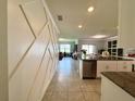 Open floorplan showcasing living room with plenty of sunlight, flowing to dining area, kitchen, and backyard at 1759 Copinger Ter, Kissimmee, FL 34744