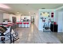 Expansive open layout with kitchen island, dining space, bar area, and living room for seamless entertaining at 1759 Copinger Ter, Kissimmee, FL 34744