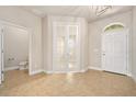 Inviting foyer features neutral paint, tile floors, and elegant French doors leading to an office at 1923 Mendocino Ln, Port Orange, FL 32128