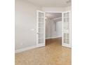 Bright office with neutral walls, tile flooring, and stylish French doors at 1923 Mendocino Ln, Port Orange, FL 32128