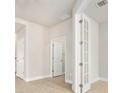 Bright office with neutral walls, tile flooring, and stylish folding doors for privacy at 1923 Mendocino Ln, Port Orange, FL 32128