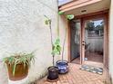 Courtyard entrance with a glass-paneled front door and potted plants at 200 Alpine St, Altamonte Springs, FL 32701