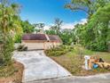Exterior view of a home with a two-car garage and a long driveway at 200 Alpine St, Altamonte Springs, FL 32701