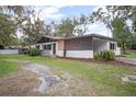 Lovely house featuring a well-kept lawn, modern color scheme, and tasteful landscaping at 2215 Lake Ruby Rd, Deland, FL 32724