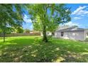 Expansive backyard featuring lush greenery and shade, ideal for outdoor activities at 2747 Date Palm Dr, Edgewater, FL 32141