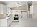 Bright kitchen with white cabinets, modern appliances, and a functional layout at 2747 Date Palm Dr, Edgewater, FL 32141