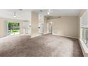 Spacious living room with plush carpeting and sliding glass doors to the backyard at 2747 Date Palm Dr, Edgewater, FL 32141