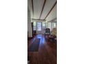 Inviting porch with rich wood flooring, stained glass accents, and comfortable seating at 27751 Luella Ave, Paisley, FL 32767
