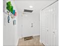 View of the entryway featuring a white door, storage closet and decorative wall art at 2987 S Atlantic # 606, Daytona Beach Shores, FL 32118