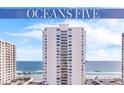 Exterior view of the condo high-rise featuring views of the beach and ocean on a sunny day at 2987 S Atlantic # 606, Daytona Beach Shores, FL 32118