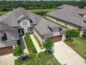 Stunning aerial view of the beautiful home, mature landscaping, and gorgeous golf course in the back at 3148 Bailey Ann Dr, Ormond Beach, FL 32174