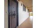 Secured entrance door featuring a metal gate providing security and privacy, with a hallway leading inside at 325 Wilder Blvd # A102, Daytona Beach, FL 32114