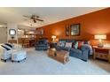 Comfortable living room featuring plush seating, a textured wall, and an open view to the dining area at 325 Wilder Blvd # A102, Daytona Beach, FL 32114