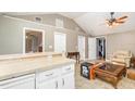 Open living room area with tiled floors, kitchen access, and ample space for furniture at 32811 County Road 473, Leesburg, FL 34788